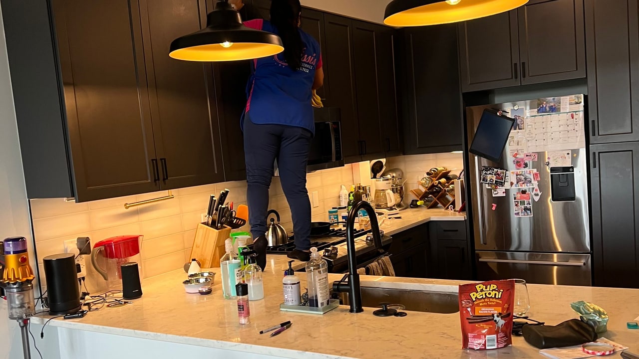A Nissi's Cleaning Service team member cleaning a kitchen